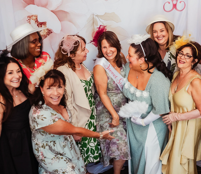 sweet sixtee birthday party at tea house, fun group of women celebrating a sixtieth birthday party wearing hats, sweet sixtee birthday sash, sweet sixtee photo backdrop